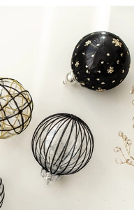 Detail of 8cm Christmas ball ornaments with gold sequins and black mesh patterns