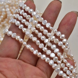 Macro shot of 4-5mm natural white freshwater baroque pearl strands with high luster finish