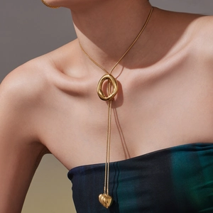 Minimalist gold Y-shaped long sweater necklace with irregular oval ring and heart pendant