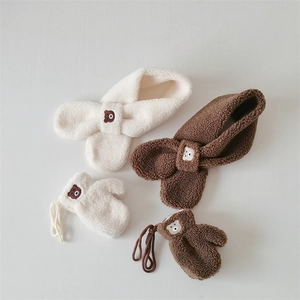 Detail of plush bear embroidery on beige and brown fleece scarf and glove sets for kids