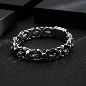 Dettaglio macro del motivo a teschio gotico sul bracciale vintage in acciaio inossidabile