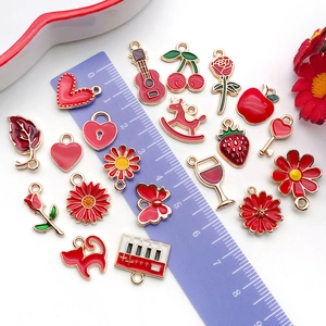 Mix of red enamel alloy charms in various shapes for DIY jewelry making with ruler