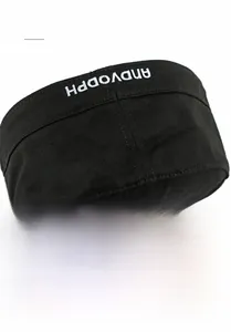 Close-up of black flat top military cap with star embroidery and fitted back closure