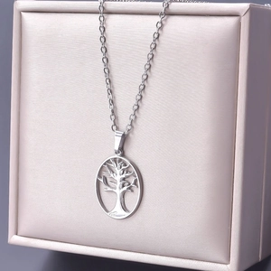 Silver tree of life pendant necklace displayed on a satin champagne jewelry box