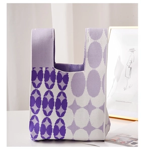 Detail of purple and white geometric knit tote bag with thick soft woven texture