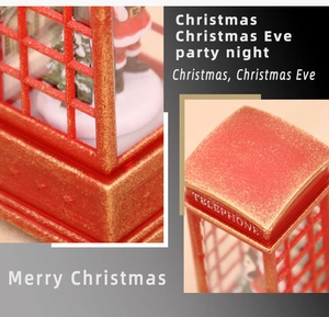Close-up of red Christmas telephone booth lamp with Santa Claus and festive glitter