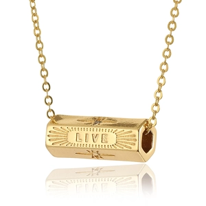 Detailed macro view of the gold-plated LIVE engraved pendant with sunburst rays