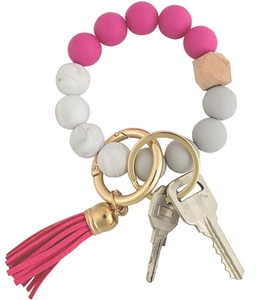 Detail of silicone bead keychain bracelet with pink tassel and wooden hexagonal bead