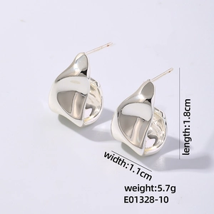 Macro detail of irregular silver metal stud earrings with liquid flow design