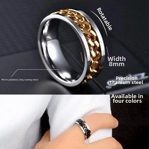 Detailed close-up of 8mm titanium steel spinner ring with golden rotating chain inlay