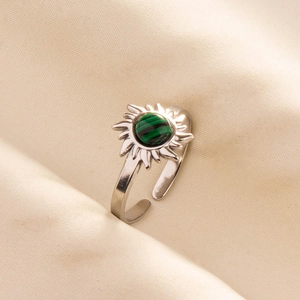 Close-up of adjustable silver steel ring with sunburst malachite stone setting