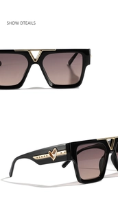 Detail of square sunglasses showing golden metal bridge and hollow heart temple design
