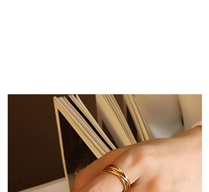 Close-up of interlocking triple band ring in 18K gold plating on a model's hand