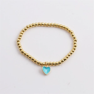 Detail of gold-plated beaded elastic bracelet with sky blue enamel heart charm