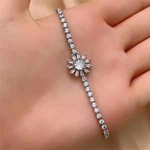 Detailed macro view of a sparkling cubic zirconia sunflower bracelet in a hand display