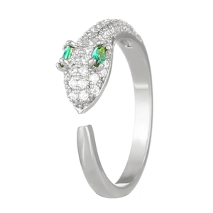 Macro detail of silver snake ring featuring zircon pave setting and green stone eyes
