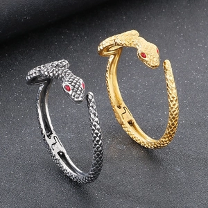 Gothic punk snake bangle in gold and silver finish with red eyes and scale texture