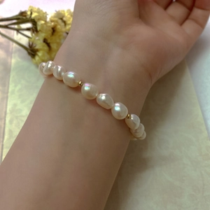 Close-up of Baroque freshwater pearl bracelet with 14K gold-filled beads on a wrist