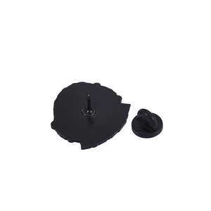 Detail view of the black metal brooch back with single pin and rubber clutch