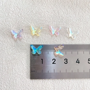 Detailed size comparison of 3D aurora resin butterfly nail charms on a ruler scale
