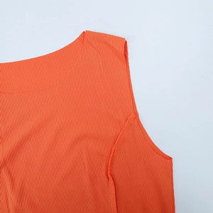 Detail of orange ribbed sleeveless top showing round neckline and elastic knit texture