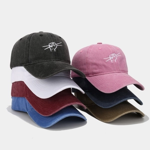 Multiple washed cotton baseball caps with drum gesture embroidery in various colors