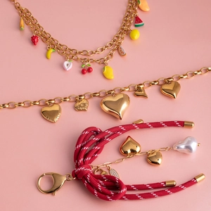 Gold titanium steel jewelry set featuring colorful fruit charms, metal hearts and a pearl