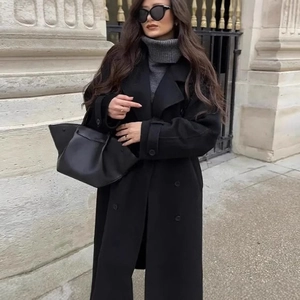 Women's classic black wool coat with double-breasted lapels in a casual loose fit style