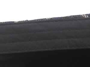 Macro detail of parallel stitching on black inner sweatband of plaid newsboy cap