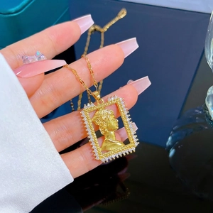 Gold plated titanium portrait pendant necklace with micro-paved cubic zirconia accents