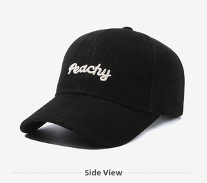 Detail of Peachy embroidery on black cotton baseball cap with twill fabric texture