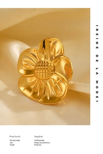 Macro detail of 18K gold plated flower ring with brushed metal texture and petal patterns