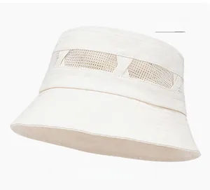 Detailed view of beige sun hat with mesh ventilation panel and breathable cotton fabric