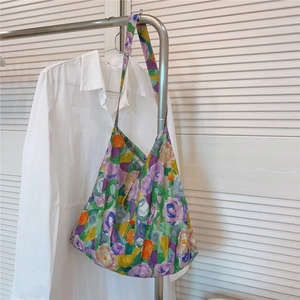 Detail of floral canvas tote bag showing colorful oil painting pattern on a soft fabric
