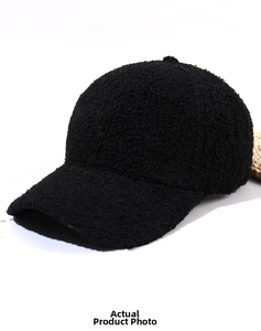 Close-up of black teddy fleece baseball cap showing thick curly sherpa texture