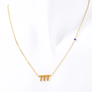 Gold titanium angel number 777 necklace featuring a purple gemstone on a delicate chain