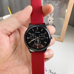 Detail of Koutake sports watch with black dial, rhinestone markers and red silicone strap