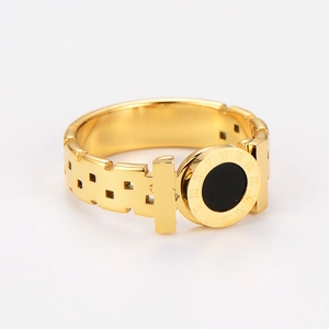 Macro shot of gold stainless steel ring featuring black round inlay and Roman numerals