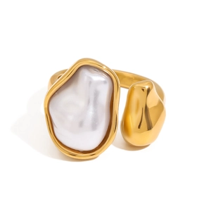 Golden open ring with irregular white pearl and polished metallic texture on white background