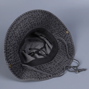 Detail of grey denim sun hat with adjustable windproof rope and copper side buttons