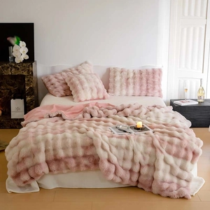 Detailed texture of pink gradient faux fur blanket with soft double-layer plush material