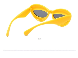 Rear view of trendy yellow cat eye sunglasses with thick frames and dark grey lenses