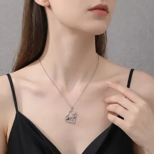 Silver heart necklace with cartoon mouse and rose pendant worn on a female model