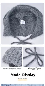 Close-up of grey wool knit hat showing thick plush texture and long adjustable drawstrings