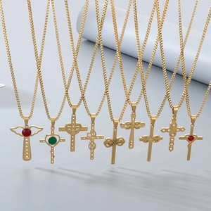 Detailed close-up of golden cross and angel necklaces with inlaid gems and pearls