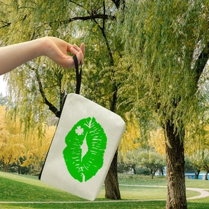 Portable canvas makeup bag featuring green lip patterns and a convenient black wristlet