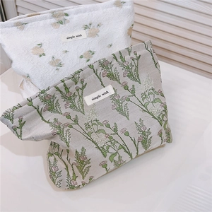 Detail of floral makeup bags with 'simple wish' label in green and beige patterns