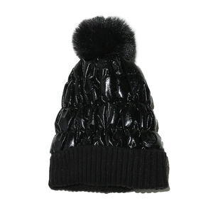 Glossy black knit winter hat with large faux fur pompom and quilted texture design