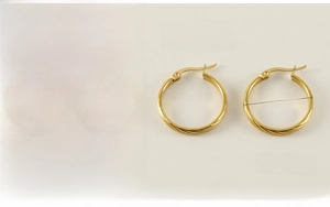 Detail view of gold hoop earrings with twisted texture and 23.7mm size parameters