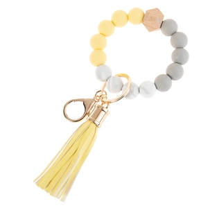 Detail of yellow and marble silicone beads with MAMA letter charm and golden keychain